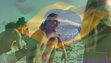 animation of flag of brazil waving over diverse friends discussing while sitting on beach