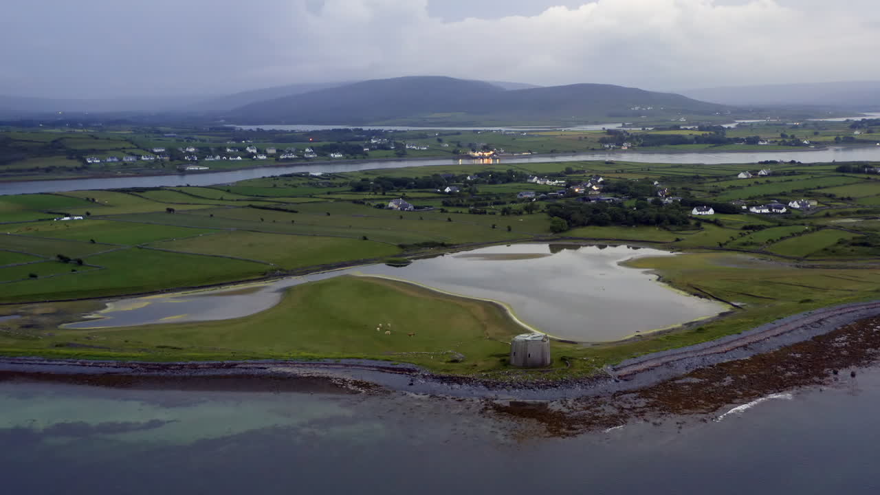 Static aerial of Aughinish Island with Martello Tower in the foreground, County Clare, Ireland