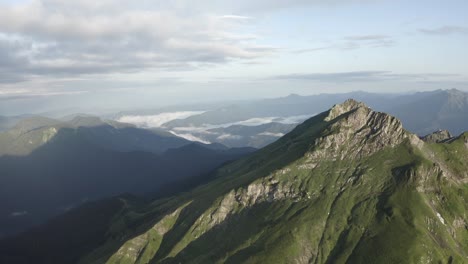 natural mountain peak cliff terrain at morning surrounded cloudy blue sky organic landscape