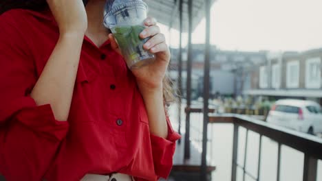 woman enjoying a mojito outside