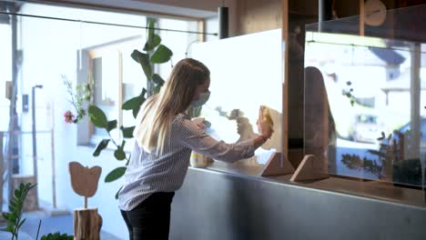 Receptionist---office-employee-disinfects-the-protective-screens-in-the-hotel-lobby---Coronavirus-tourism-footage