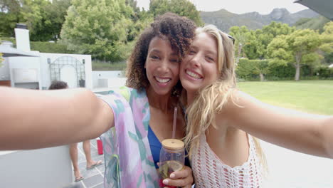 Biracial-woman-and-young-Caucasian-woman-enjoy-an-outdoor-event