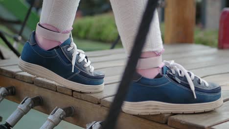 child walking on a playground bridge