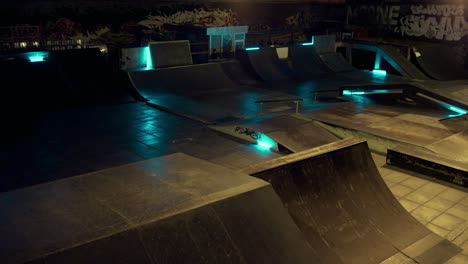 energetic guy jumping roller skates in safety helmet at night skate park.