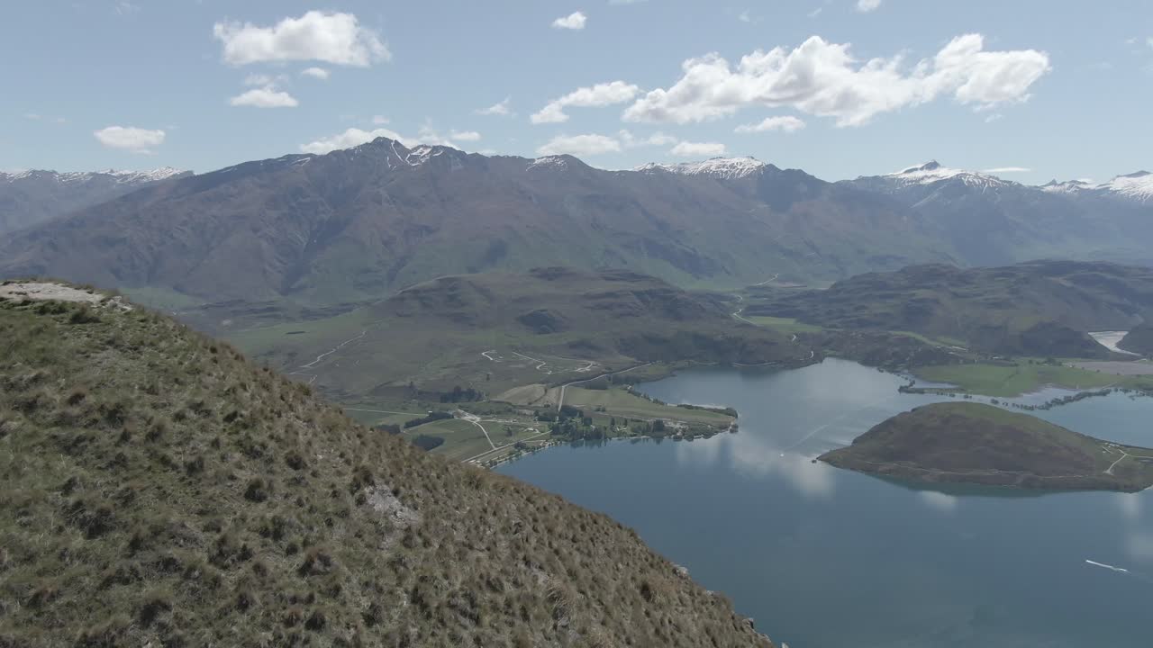drone shot of the lake wanaka and mountains and sky