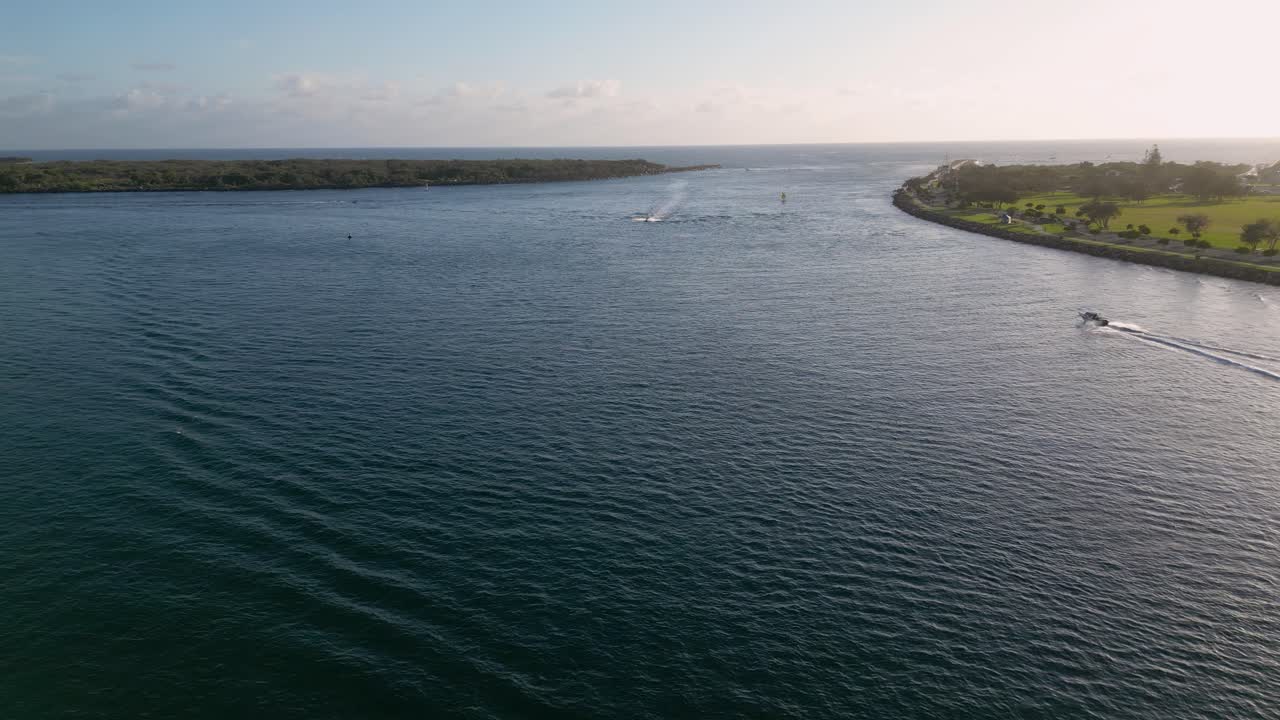 Aerial views over The Spit and seaway on the northern end of the Gold Coast in the morning on a sunny day.