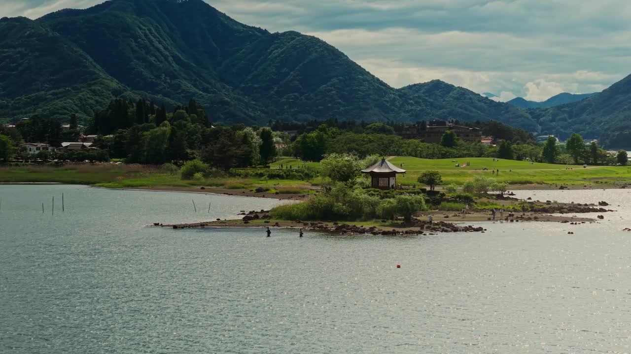 Picturesque Lake Landscape with Mountains and a Japanese Gazebo