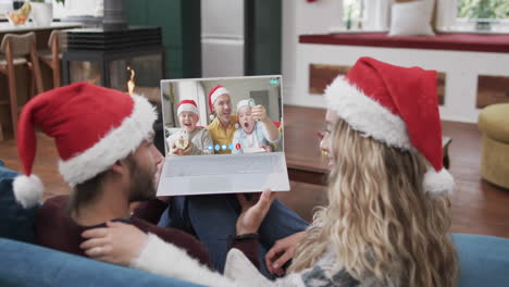 Happy-caucasian-couple-and-father-with-sons-having-christmas-laptop-video-call,-slow-motion