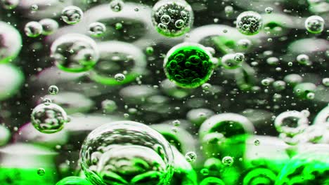 macro shot of a swirl with green bubbles in water