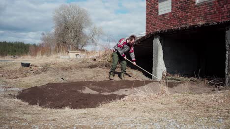 Raking-Soil-For-Farming-In-Indre-Fosen,-Norway---Wide-Shot