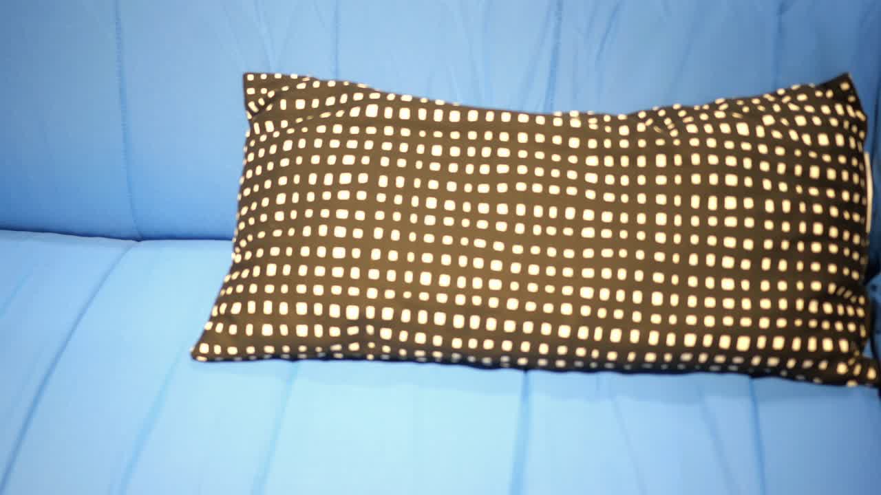 Black and White Square Pattern Pillow on Blue Sofa