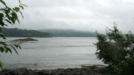 Wide-angle-overview-of-misty-clouds-above-Maine-mountains-at-the-mouth-of-reversing-falls