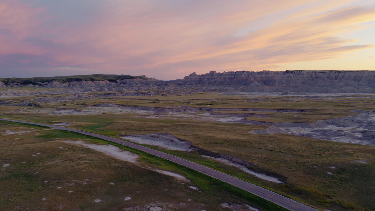 Golden Sunset Light Over Rugged Badlands Landscapes Captured by Drone