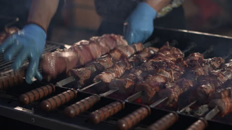 closeup pork kebabs barbecuing at brazier. bbq meat grilling on skewers