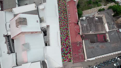 drone panning down on buildings and umbrella covers