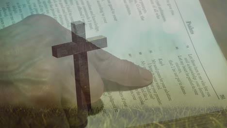 animation of christian cross and person with finger on holy bible