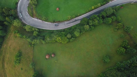 A-winding-road-in-the-summer-green-from-the-mountain-village-of-Dambovicioara-in-Romania
