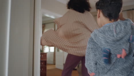 happy-little-boy-chasing-mother-with-watering-can-playing-catch-running-through-house-mom-enjoying-fun-game-with-child-enjoying-weekend-morning-together-4k-footage