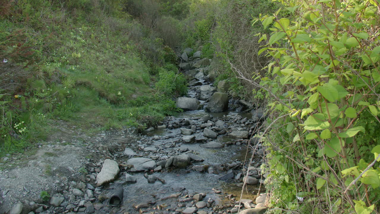 Extra wide shot of a small rocky stream brook at new quay beach