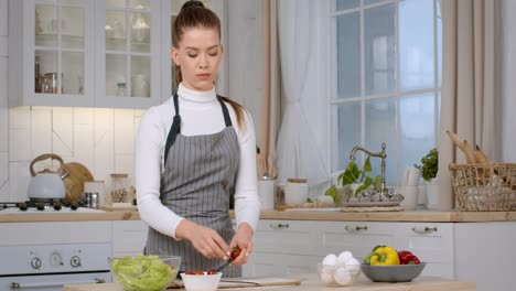 woman preparing a salad in a kitchen