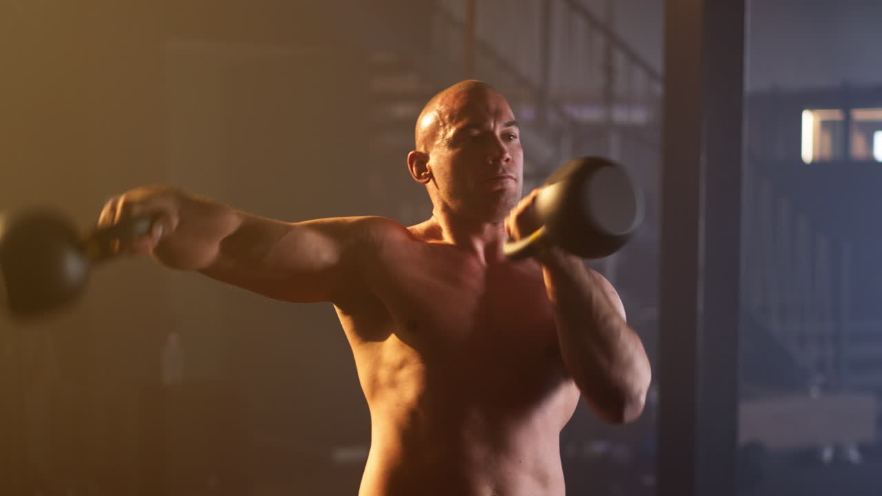 Man working out with kettlebell in gym