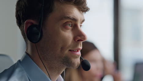 portrait call center specialist talking microphone. focused man helping client