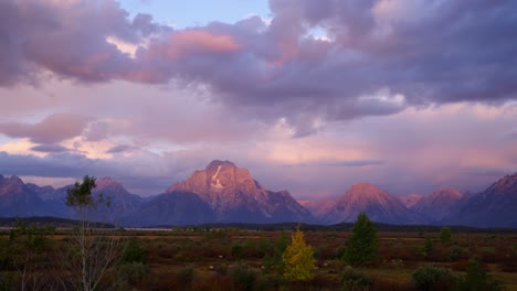 pink sunrise time lapse over mt. moran in grand teton national park, wyoming