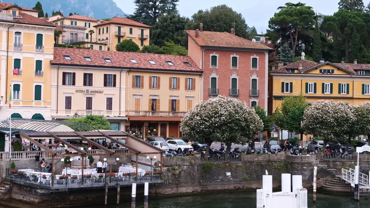 LOMBARDY, ITALY - AUGUST 02, 2018: Cinematic shot of Bellagio town, Como lake and mountains from a boat