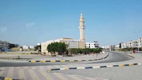 driving. travelling. road through egyptian town. car moves around the outskirts of some egyptian city. view of houses from car side window