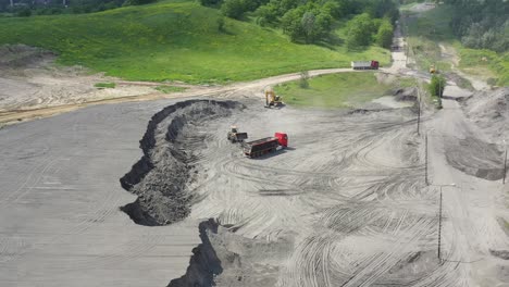 Aerial-view-loading-bulldozer-in-open-air-quarry