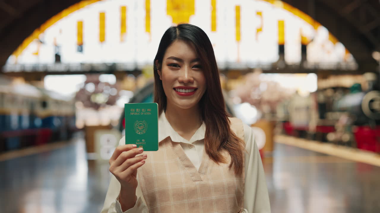 Smiling Woman Holding Passport at Train Station