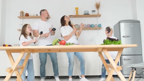 insanely happy family with two children dancing in the kitchen with a modern interior insanely happy family with two children dancing in the kitchen with a modern interior dancing family great mood