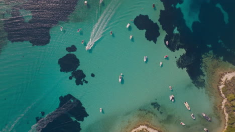 aerial view of boats in crystal clear water