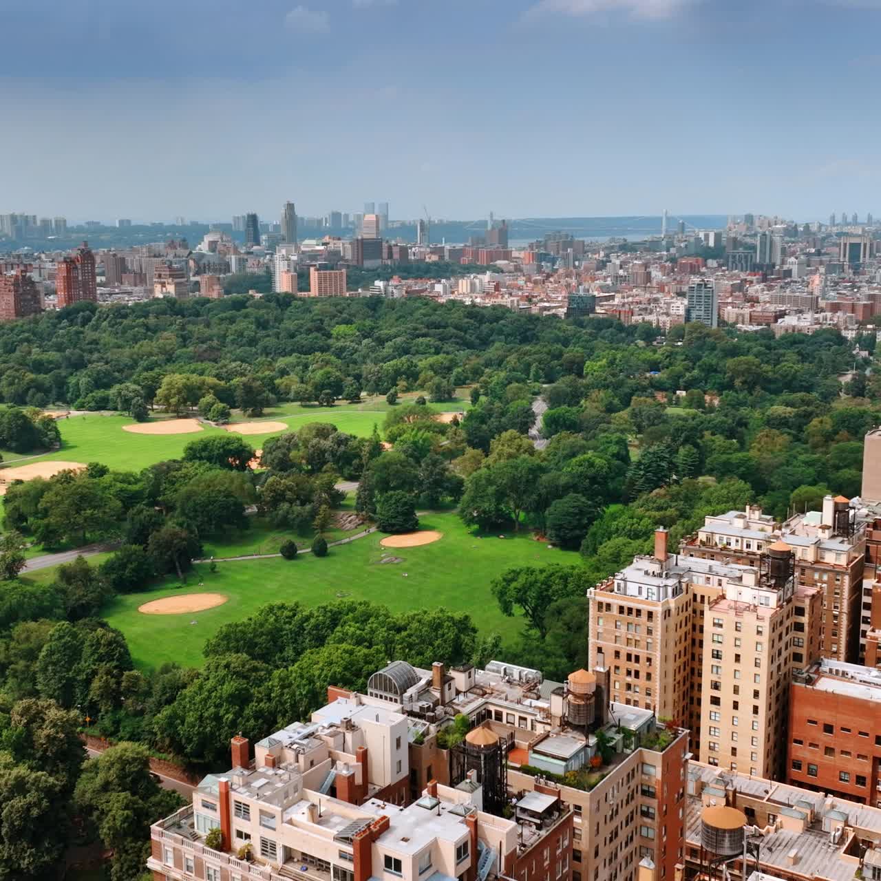 Beautiful green park and great architecture of New York. Sunny scenery of a wonderful metropolis from top perspective
