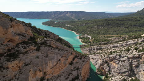 turquoise blue water of verdon gorges aerial shot along the limestone cliff