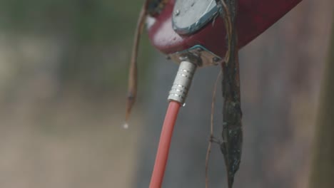 water hose attached to a metal pipe outdoors