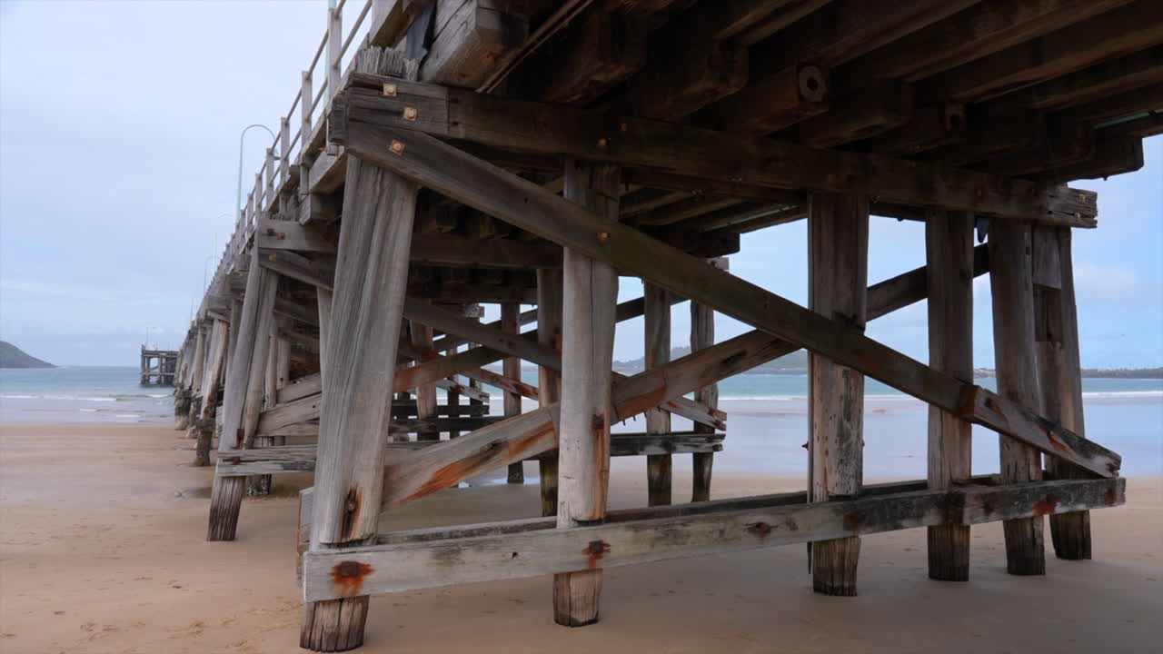 Wide shot of the wooden frame of the Coffs Harbour Jetty, New South Wales Australia