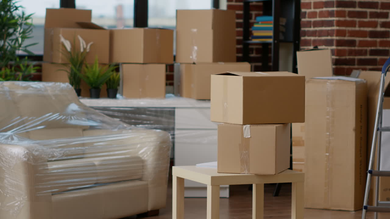 No people in empty living room apartment with carton boxes