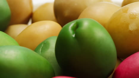 pickled round green olives from greece as background, top view. high quality 4k footage