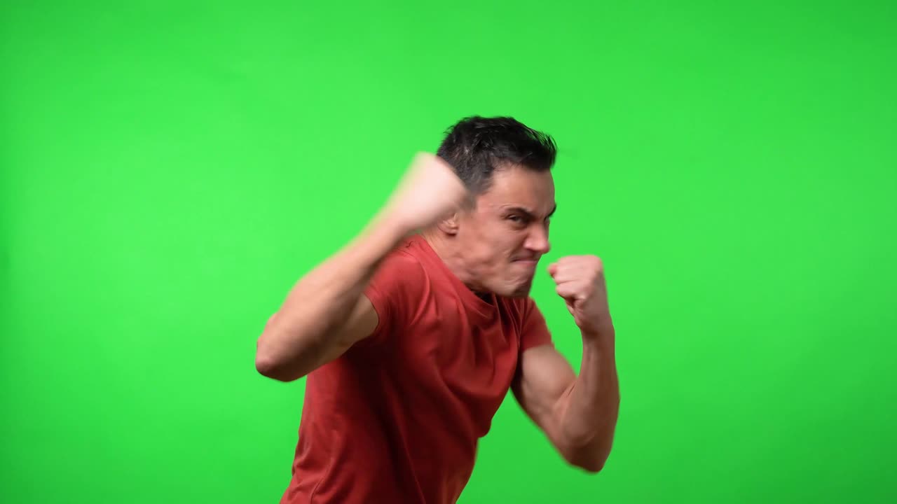 Aggressive man looking for a fight showing violently his fists,