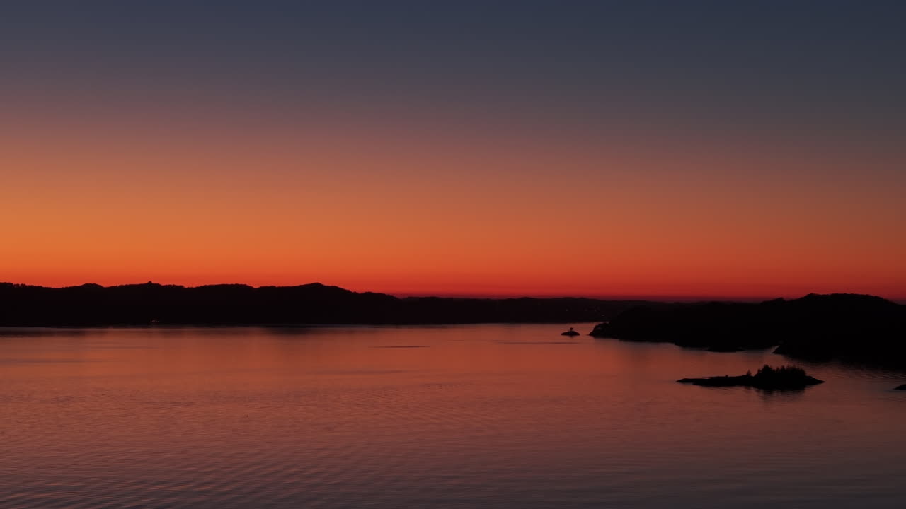 Aerial panorama of the Norwegian coast, bathed in the warm afterglow of sunset