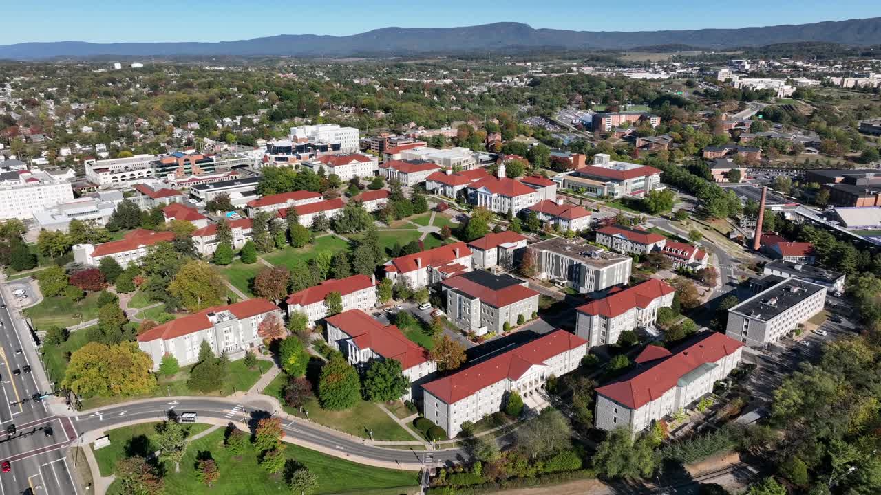Traffic on main highway street beside James Madison University Campus at sunlight. Beautiduk sunny day in autumn season. Aerial wide shot. Cityscape of Harrisonburg, VA