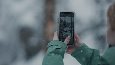 taking pictures in a snowy forest