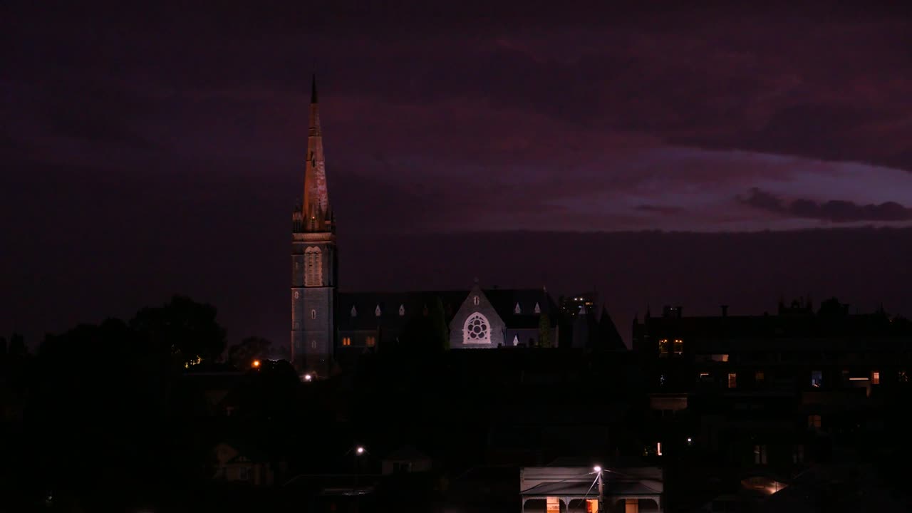 A dramatic church scene set against a dark and dramatic background.