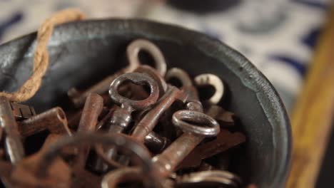 soft pan of bowl full of old rusty steel keys at a home reception