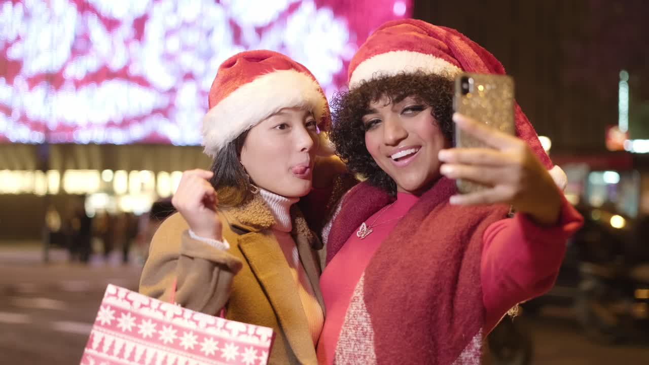 Friends taking a festive Christmas selfie in the city
