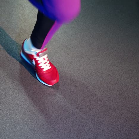 healthy lifestyle and sport concepts. woman in fashionable sportswear is doing exercise with skipping rope.