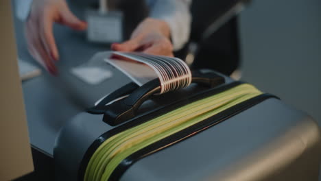 Woman checking in luggage at airport