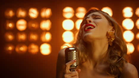 passionate singer performing solo on stage close up. blonde vocalist making show