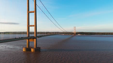 a cinematic journey: humber bridge, cars beneath the setting sun